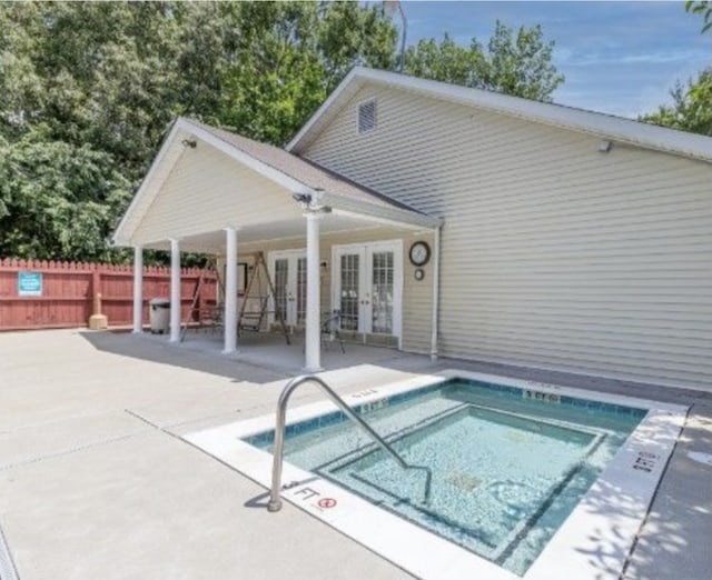 view of pool featuring a patio and french doors