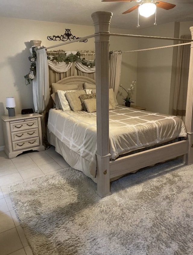 tiled bedroom featuring ornate columns and ceiling fan