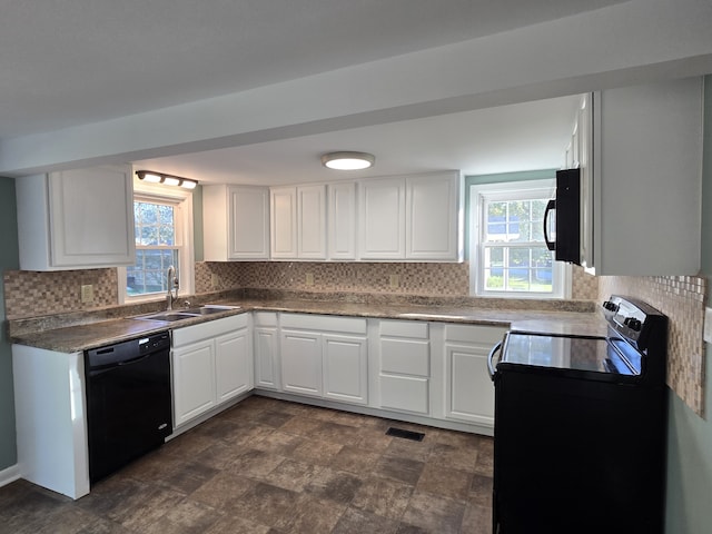 kitchen with white cabinets, a wealth of natural light, sink, and black appliances