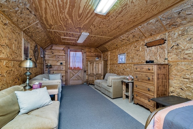 carpeted bedroom with vaulted ceiling and wooden walls