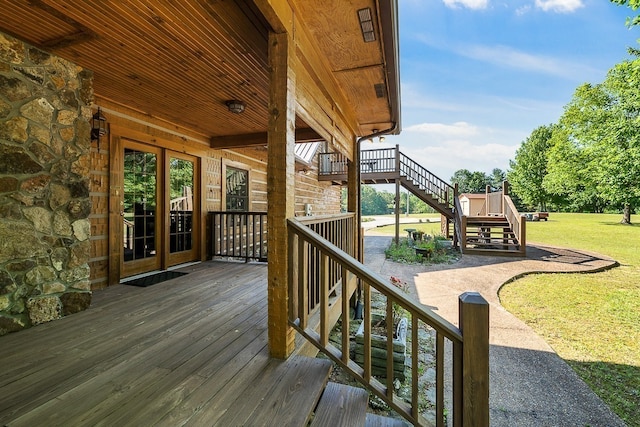 deck with a patio and a lawn