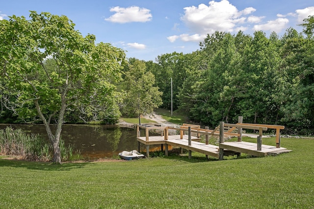 dock area featuring a water view and a yard