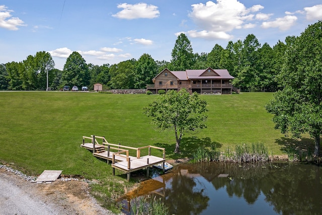 exterior space featuring a lawn and a water view