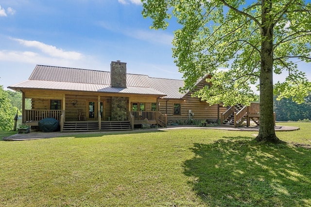 back of property featuring a lawn