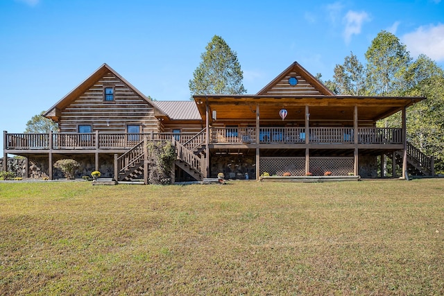 back of house featuring a deck and a yard