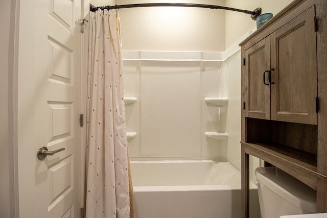 bathroom featuring shower / bath combination with curtain and toilet