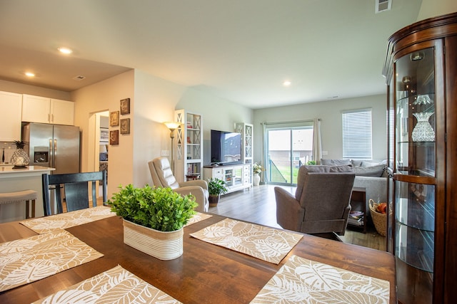 dining area featuring dark wood-type flooring