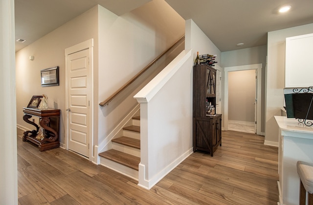 stairs featuring hardwood / wood-style flooring