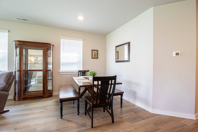 dining space with light hardwood / wood-style floors