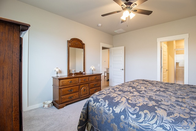 bedroom featuring ensuite bathroom, ceiling fan, and light colored carpet