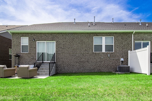 back of house with outdoor lounge area, a yard, and central air condition unit