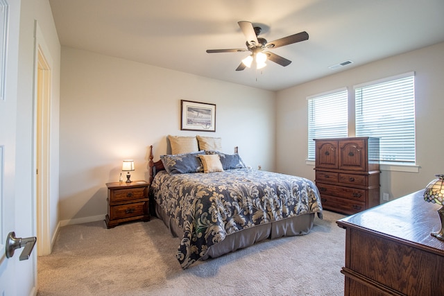 bedroom with light carpet and ceiling fan