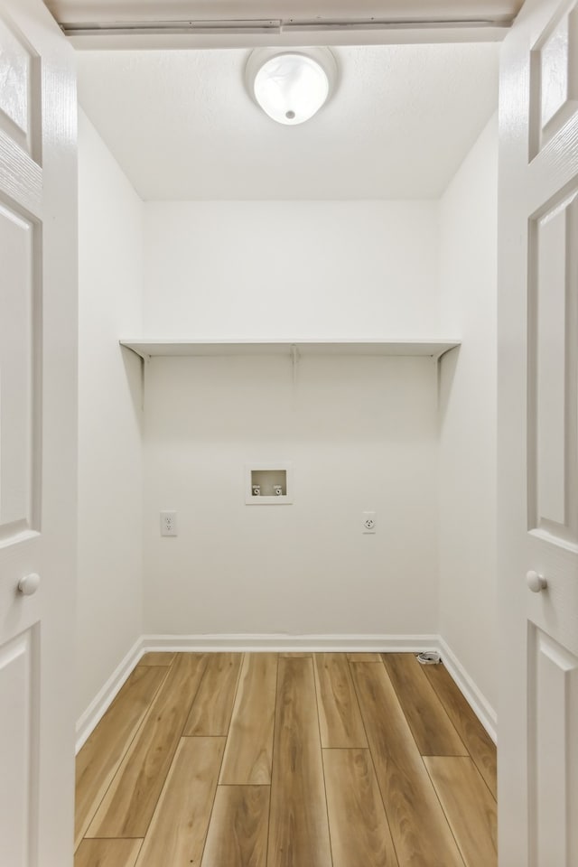 washroom featuring hookup for an electric dryer, wood-type flooring, and hookup for a washing machine