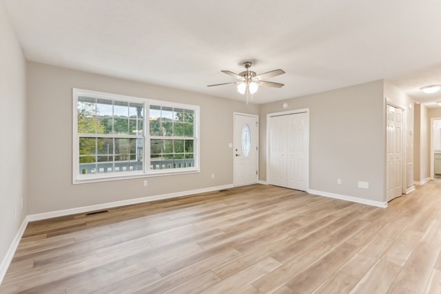 empty room with light wood-type flooring and ceiling fan