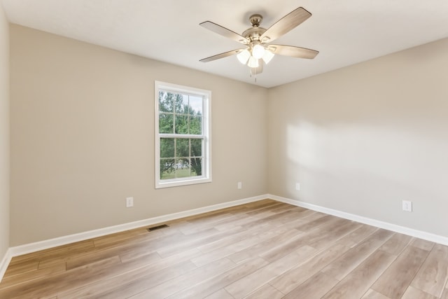 empty room featuring light wood-type flooring and ceiling fan