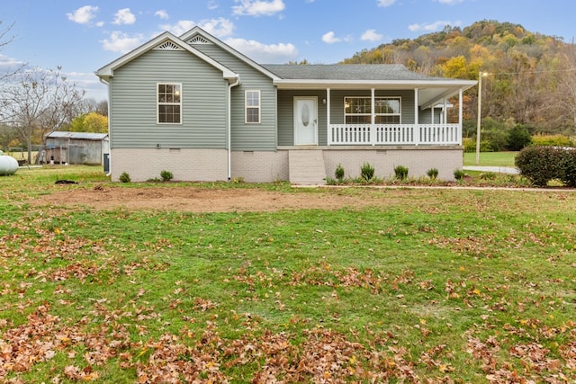 view of front of property with a porch and a front lawn