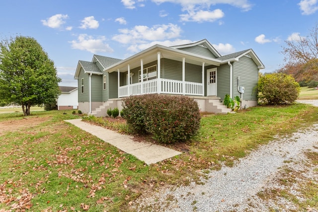 view of front of property with a front yard and covered porch