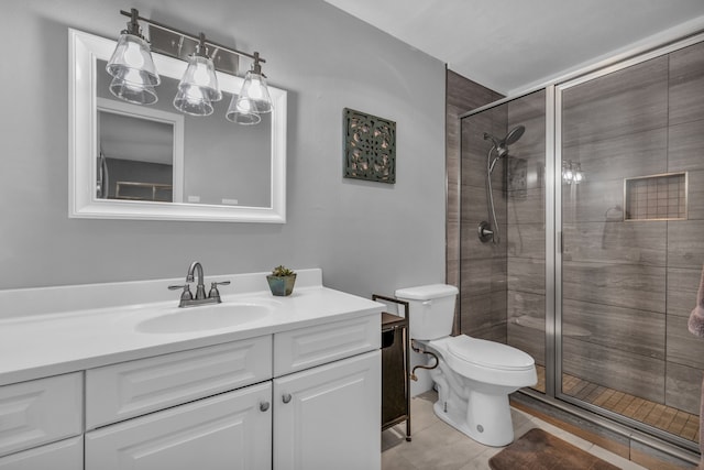 bathroom with an enclosed shower, vanity, tile patterned flooring, and toilet