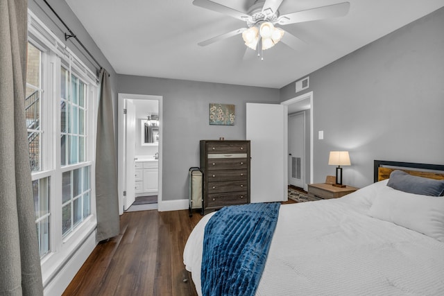 bedroom with dark wood-type flooring, connected bathroom, and ceiling fan