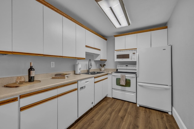 kitchen with dark wood-type flooring, white appliances, sink, and white cabinets