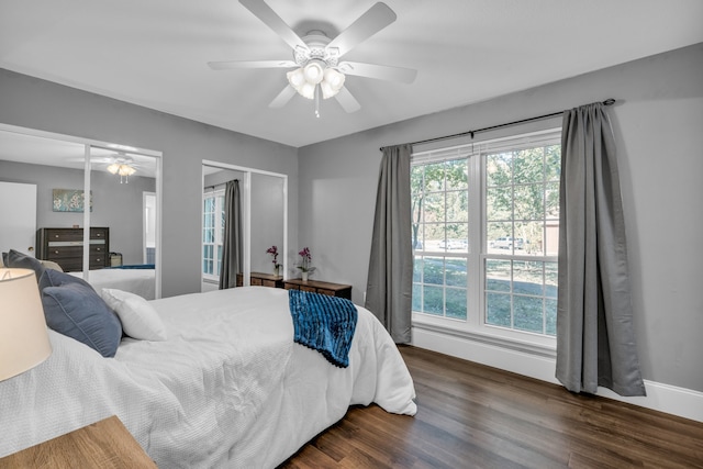 bedroom featuring multiple windows, ceiling fan, and dark hardwood / wood-style flooring