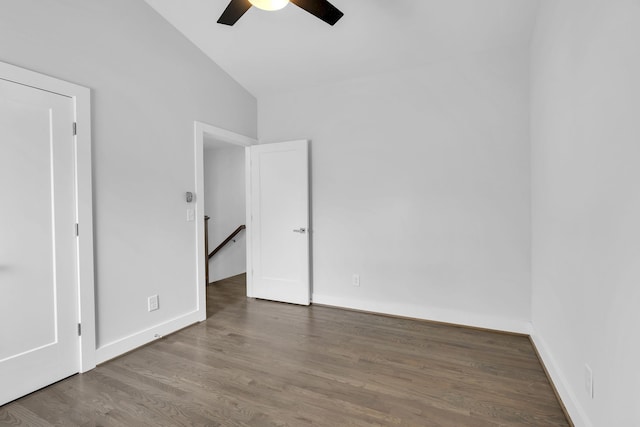 spare room featuring ceiling fan, lofted ceiling, and dark hardwood / wood-style floors