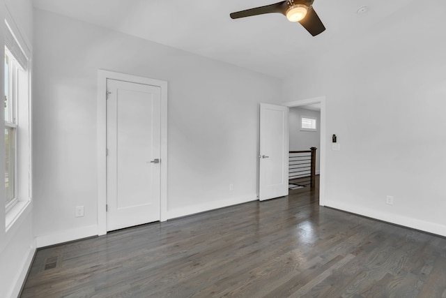 unfurnished room with dark hardwood / wood-style flooring and ceiling fan