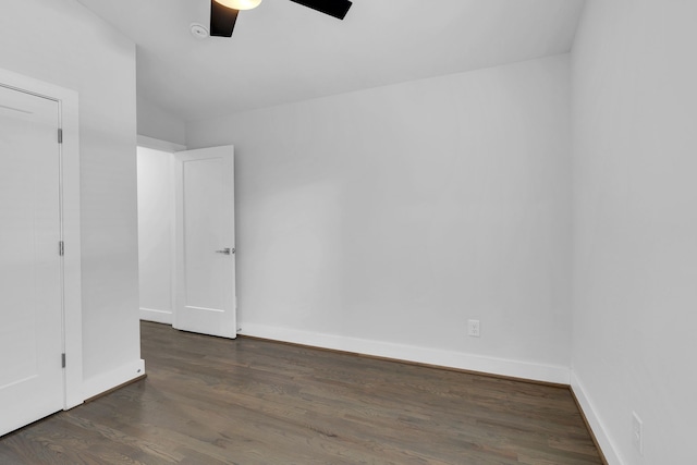 unfurnished room with ceiling fan, vaulted ceiling, and dark hardwood / wood-style flooring