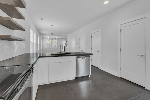 kitchen with stainless steel appliances, white cabinets, sink, kitchen peninsula, and a chandelier