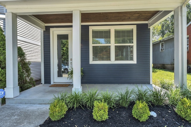 view of exterior entry featuring a porch