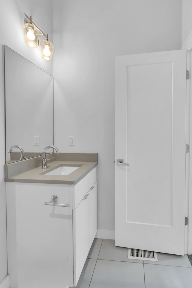 bathroom featuring tile patterned flooring and vanity