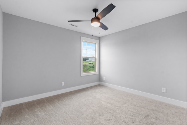 spare room with carpet and ceiling fan