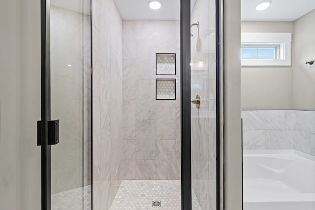 bathroom with shower with separate bathtub