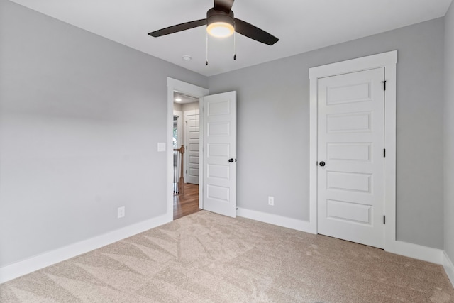 unfurnished bedroom with a closet, ceiling fan, and carpet flooring