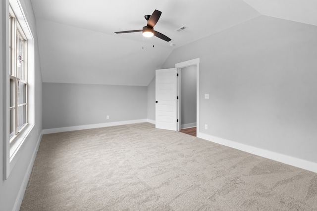 bonus room with ceiling fan, lofted ceiling, and dark carpet