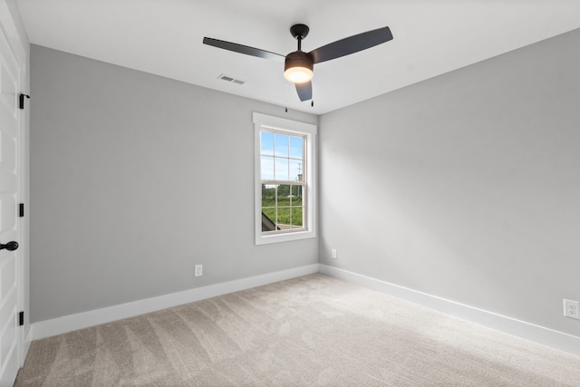 carpeted spare room featuring ceiling fan