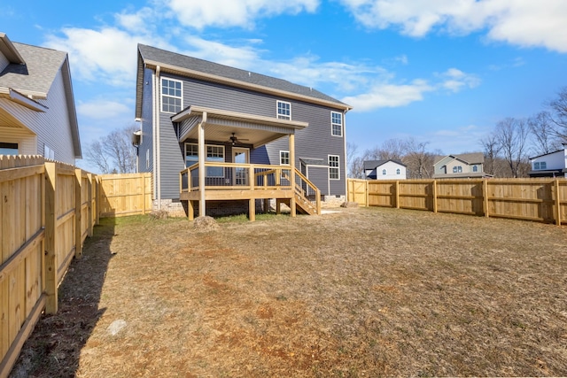 rear view of house with a deck and ceiling fan