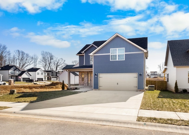 view of front facade featuring a garage, central AC, and a front yard