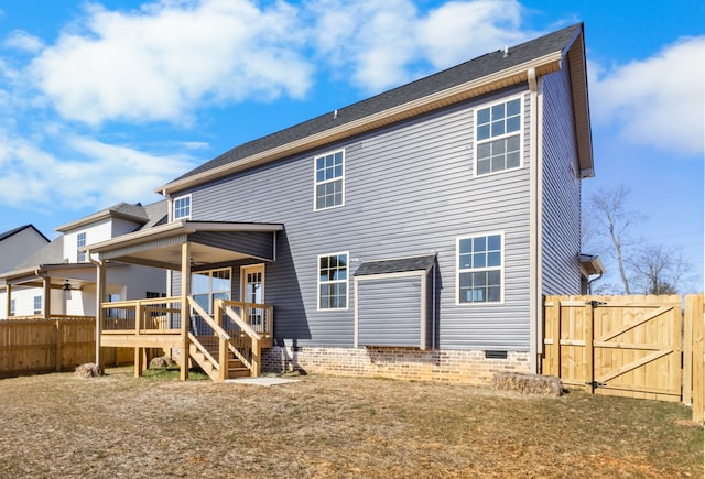 rear view of house featuring a wooden deck, a yard, and ceiling fan