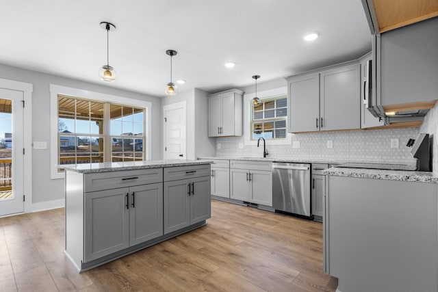 kitchen with sink, gray cabinets, hanging light fixtures, a kitchen island, and stainless steel dishwasher