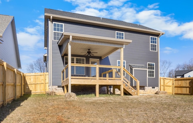 rear view of property featuring a wooden deck and ceiling fan