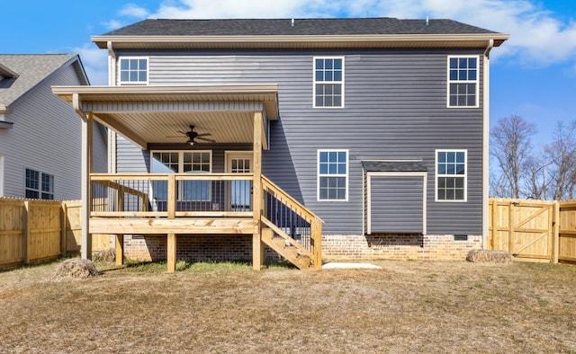 rear view of house featuring a deck and ceiling fan