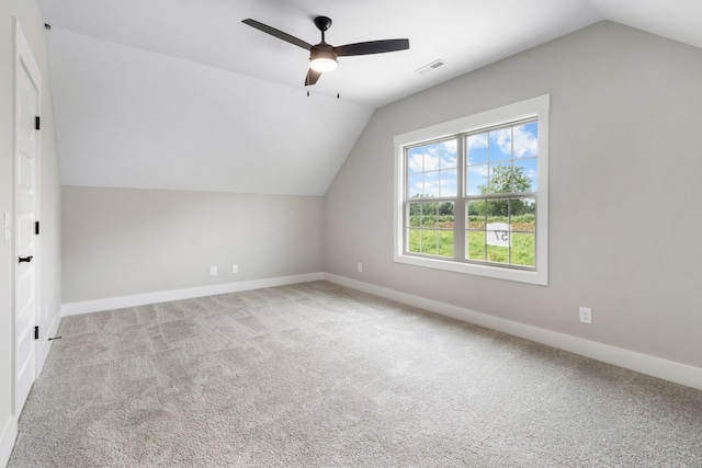 additional living space with lofted ceiling, light colored carpet, and ceiling fan