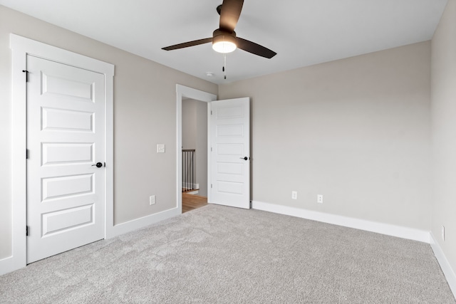 unfurnished bedroom featuring light colored carpet and ceiling fan