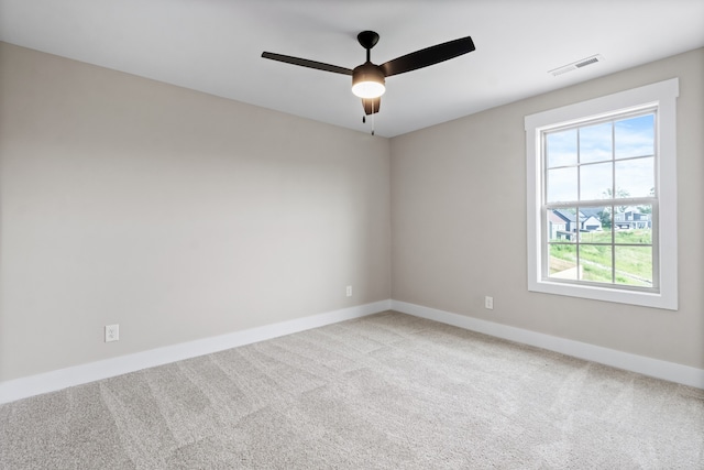 spare room with carpet floors and ceiling fan