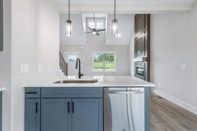 kitchen with dishwasher, sink, pendant lighting, and a healthy amount of sunlight