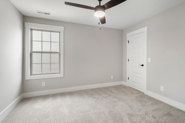 carpeted empty room featuring ceiling fan