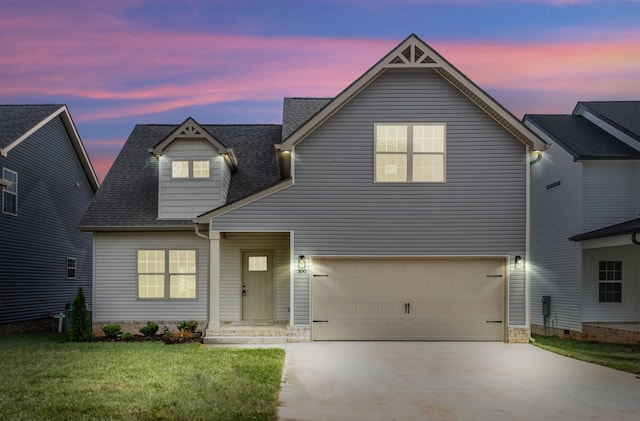 view of front of home featuring a garage and a lawn