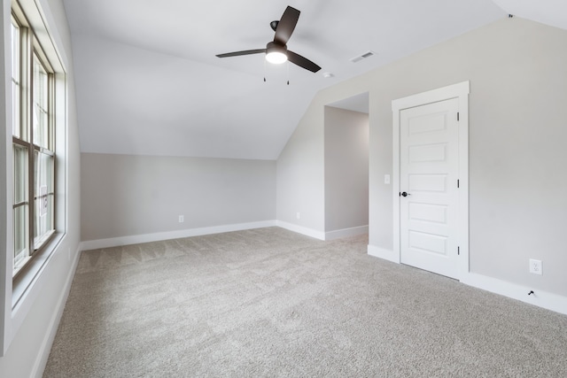 bonus room featuring lofted ceiling, light carpet, and ceiling fan