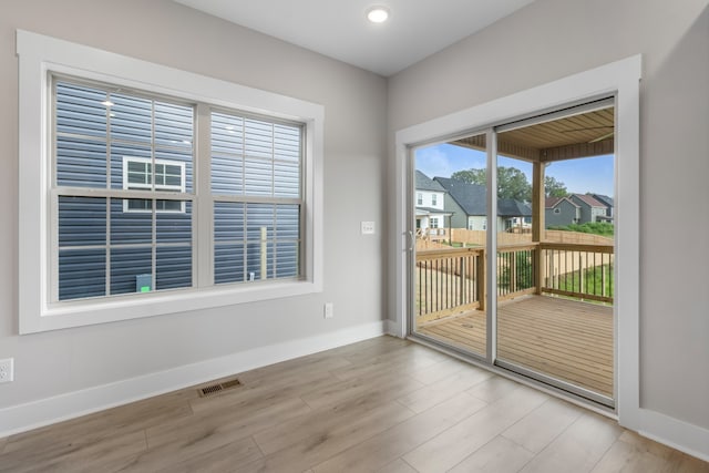 unfurnished room with light hardwood / wood-style floors